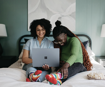 Two women collaborating on a laptop